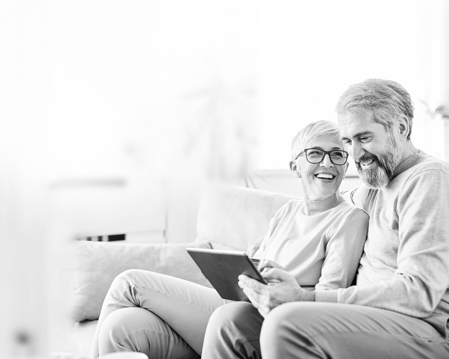 portrait of happy smiling senior couple using tablet at home